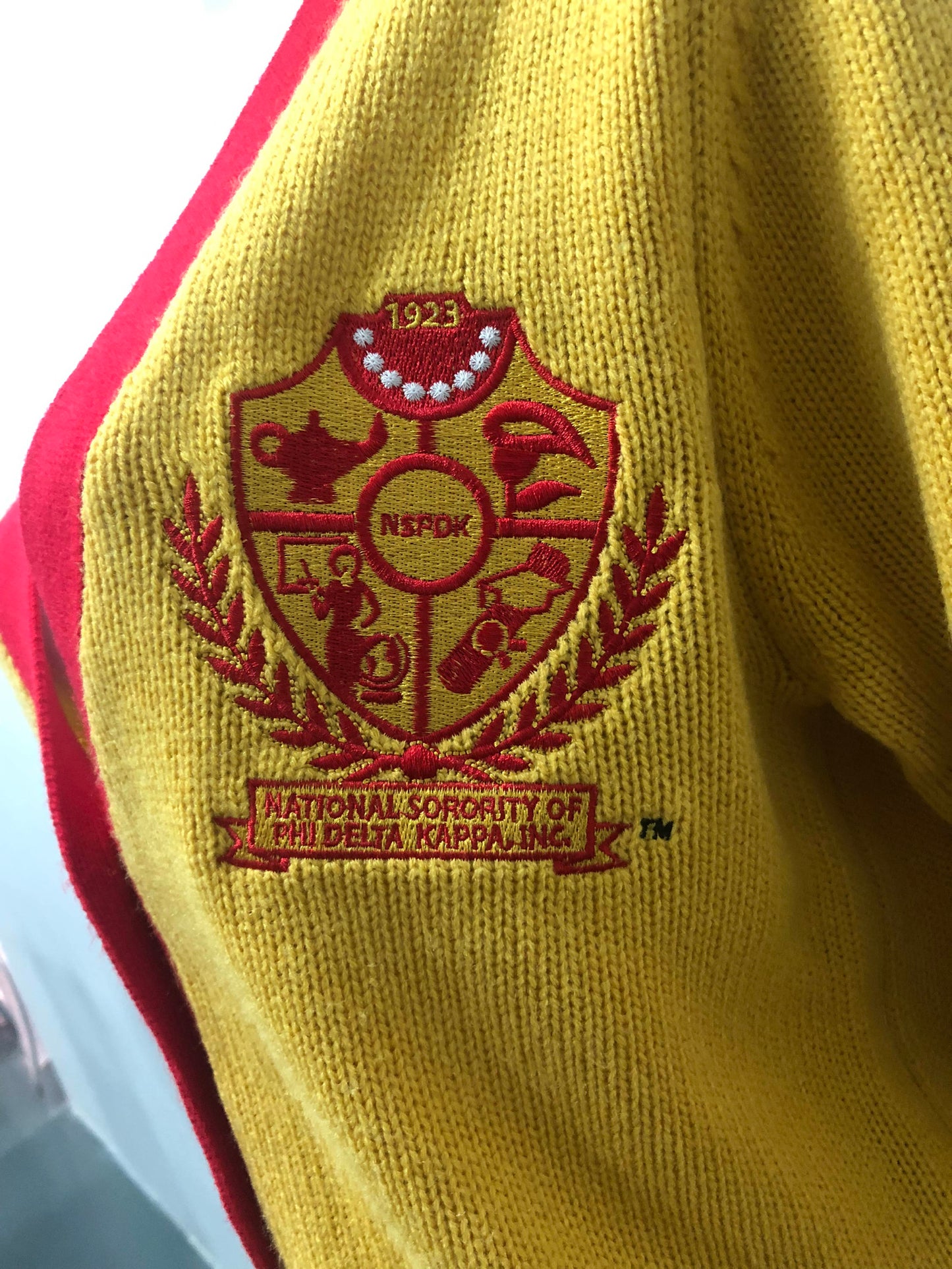 Gold Cardigan with Crest and Red Trim